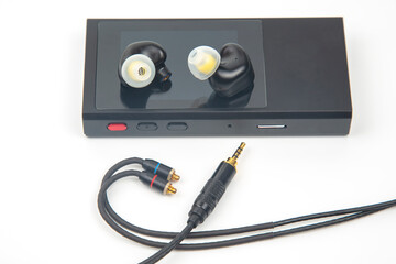 In-ear headphones for Hi-Fi music player. Audio sound and modern equipment for music lovers