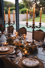 Christmas table with candles, flowers and glass cups.