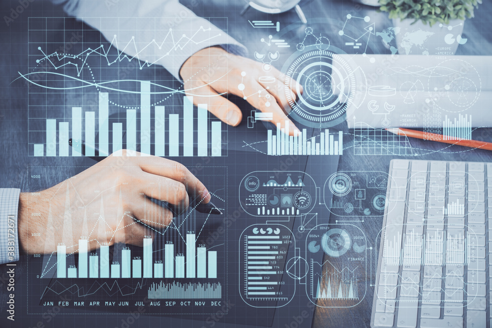 Wall mural double exposure of man's hands holding and using a phone and financial graph drawing. analysis conce