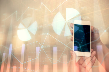 Double exposure of forex graph sketch hologram and woman holding and using a mobile device. Stock market concept.