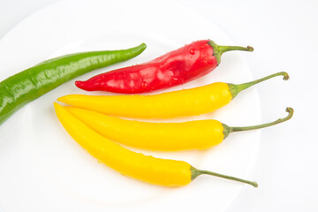 Colored hot chili on a plate. Pepper. Vegetable vitamin food