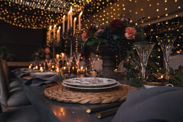 Christmas table with candles, flowers and fruits