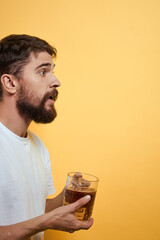 Man with a mug of beer fun alcohol lifestyle white t-shirt yellow isolated background