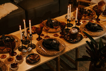 Christmas table with candles, glasses and decorations