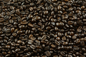 Food background of closeup of extra dark French whole bean coffee 
