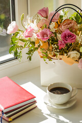 romance and tenderness greeting card concept. mixed flowers bouquet and coffee cup on a window sill composition. copy space. take a brake conceptual