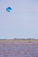 man kitesurfing alone in a lagoon