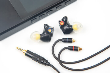 In-ear headphones for Hi-Fi music player. Audio sound and modern equipment for music lovers