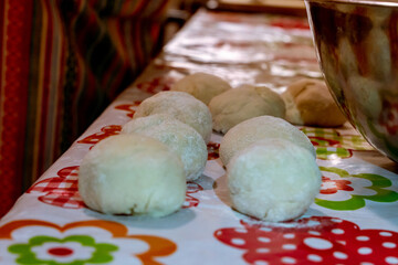 raw balls of bread in the kitchen table