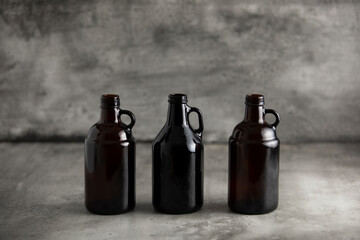 beer growler bottles for craft beer with white space for a copy over a grey background