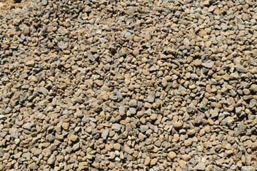 Brown and grey pebble stone texture on the ground.