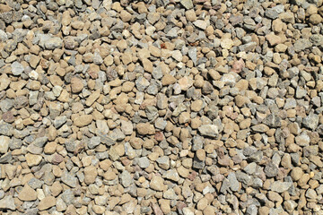 Brown and grey pebble stone texture on the ground.
