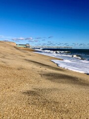 beach and sea next to a pier