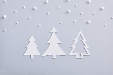 Obraz premium White fir tree shape with snowfall on pastel background