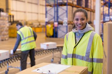 Fototapeta premium Portrait smiling female worker in distribution warehouse