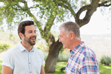 Fototapeta premium Happy father and adult son in park