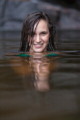 Fototapeta premium Portrait beautiful young woman swimming in lake