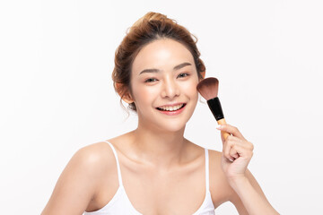 Beautiful Asian young woman smile and holding make up brush with healthy Clean and Fresh skin feeling so happiness and cheerful,Isolated on white background,Beauty Cosmetics Concept