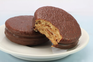 bite chocolate donuts on a white background