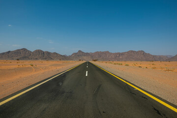 Fototapeta na wymiar Desert road in remote rural area of Tabuk in north western Saudi Arabia