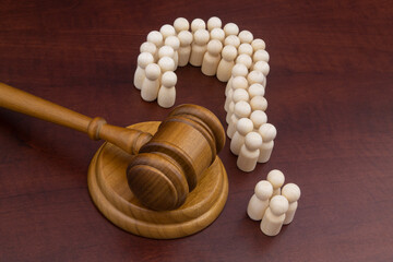 Legal questions and answers concept, social rights theme. Many people as question mark and wooden...