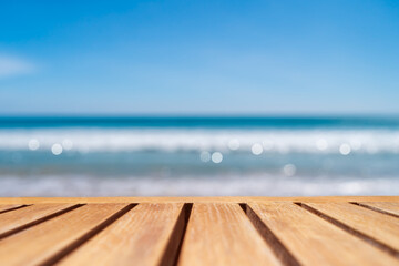 Obraz na płótnie Canvas Selective focus of old wood table with beautiful beach background for display your product.