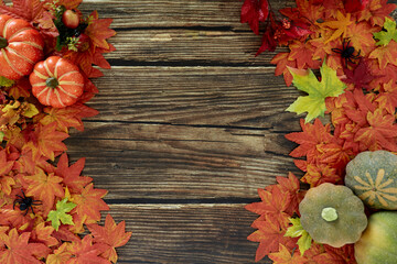 Top view Autumn leaves and pumpkins wooden