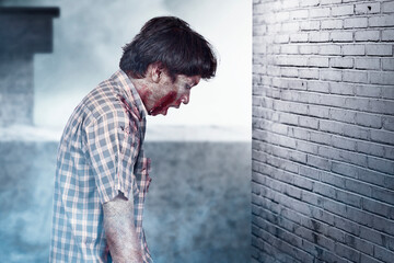Scary zombie with blood and wound on his body standing