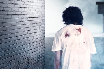 Obraz premium Scary zombie with blood and wound on his body standing