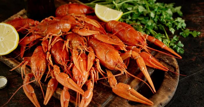 Boiled crayfish with herbs and lemon slowly rotate. 