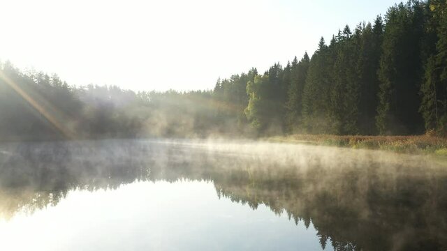 mist over lake at morning time