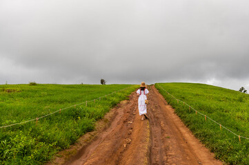 Young woman feel relaxing on green grass mountain