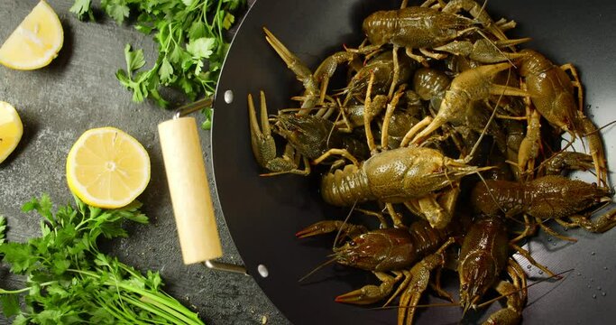 The pot with live crayfish is slowly rotating. 