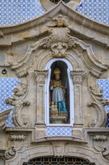 Details of facade statue of Saint Nicholas at Parish Church of St. Nicholas or Igreja de Sao Nicolau in Porto, Portugal