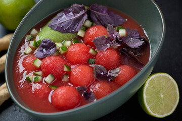 Bowl of gazpacho cold soup made of tomatoes and watermelon, selective focus, close-up
