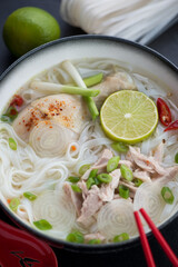 Closeup of vietnamese chicken rice noodle soup or Pho Ga, vertical shot, selective focus
