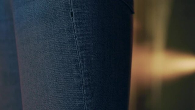 A painting robot paints jeans in a jeans factory. technological factory. industrial robot.