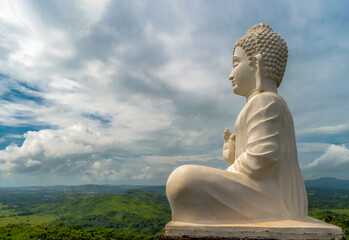 Amazing photo of Lord Buddha statue in white, sitting in meditation pose while giving sermons at...