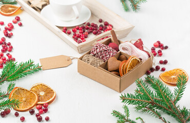 Obraz na płótnie Canvas Zero waste Christmas concept. Hand crafted christmas gift wrapping without plastic, cranberries, pine cones and branches.