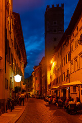 Fototapeta na wymiar Busy typical street of ancient Italian city of Trento in autumn evening..
