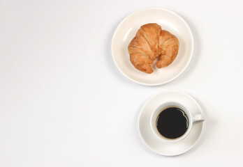 flat lay of coffee cup and croissant on white  background with copy space. Morning coffee and snack.