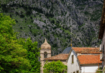 Obraz premium View onto Saint Nicholas or Nikole church over the red terracotta tile rooftops of the Old Town of Kotor, Montenegro