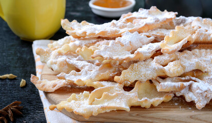 Brushwood - crispy deep fried cookies in powdered sugar with tea and jam. A traditional treat at European festivals.
