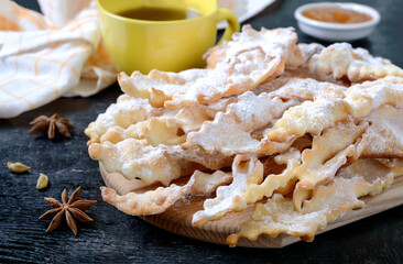 Brushwood - crispy deep fried cookies in powdered sugar with tea and jam. A traditional treat at European festivals.