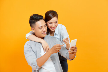 Couple or friends laughing funny and having fun with a smart phone