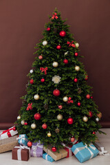 Christmas tree pine with gifts new year decor garland interior of the holiday house December