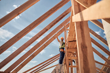 Serious young foreman controlling work on construction site