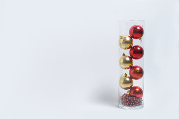 red and gold Christmas toys in a vase on a white isolated background New Year's layout banner space for text