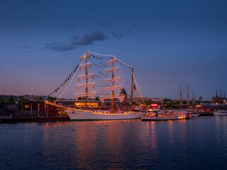 By night, aAerial view of Armada exhibition greatest sailboats at Rouen dock on Seine river....