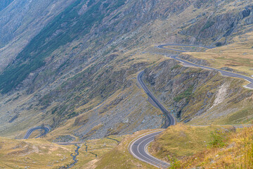Transfagarasan road in Romania - curved amazing motorway through the mountains from Transylvania in a cloudy day with spectacular sky